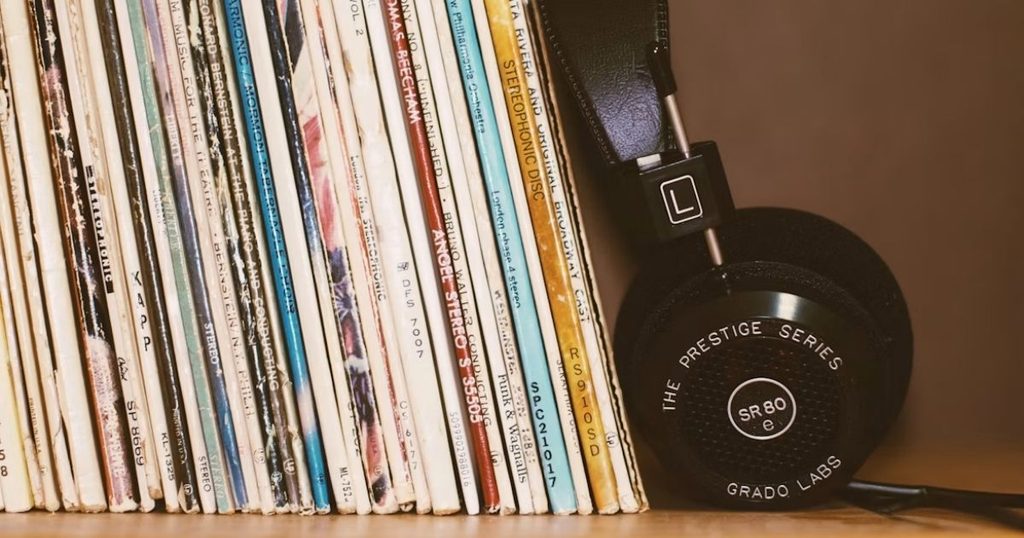 建てられたたくさんのレコードにヘッドホンが寄りかかって置かれている写真
